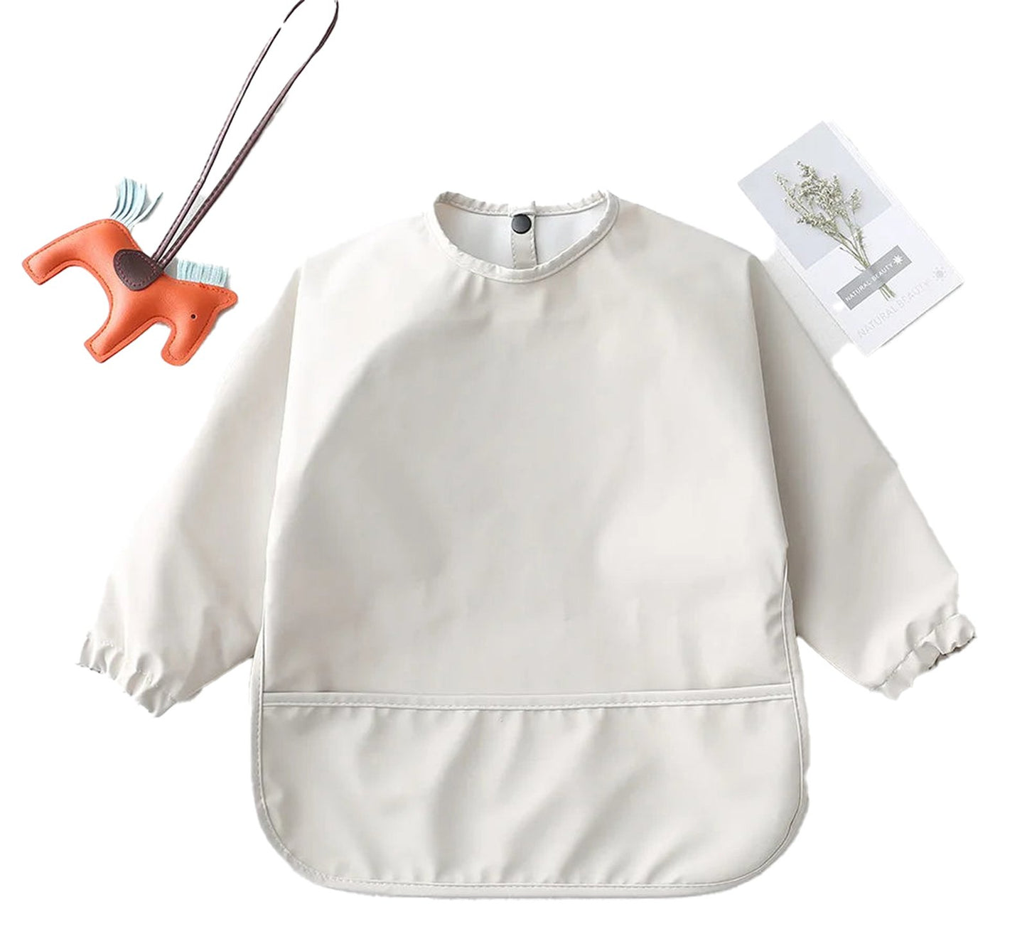 Light beige waterproof baby art smock with long sleeves and a pocket for mess-free creative activities