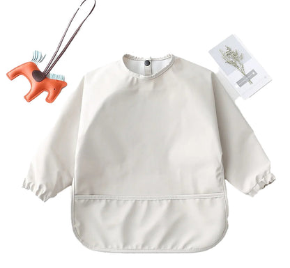 Light beige waterproof baby art smock with long sleeves and a pocket for mess-free creative activities