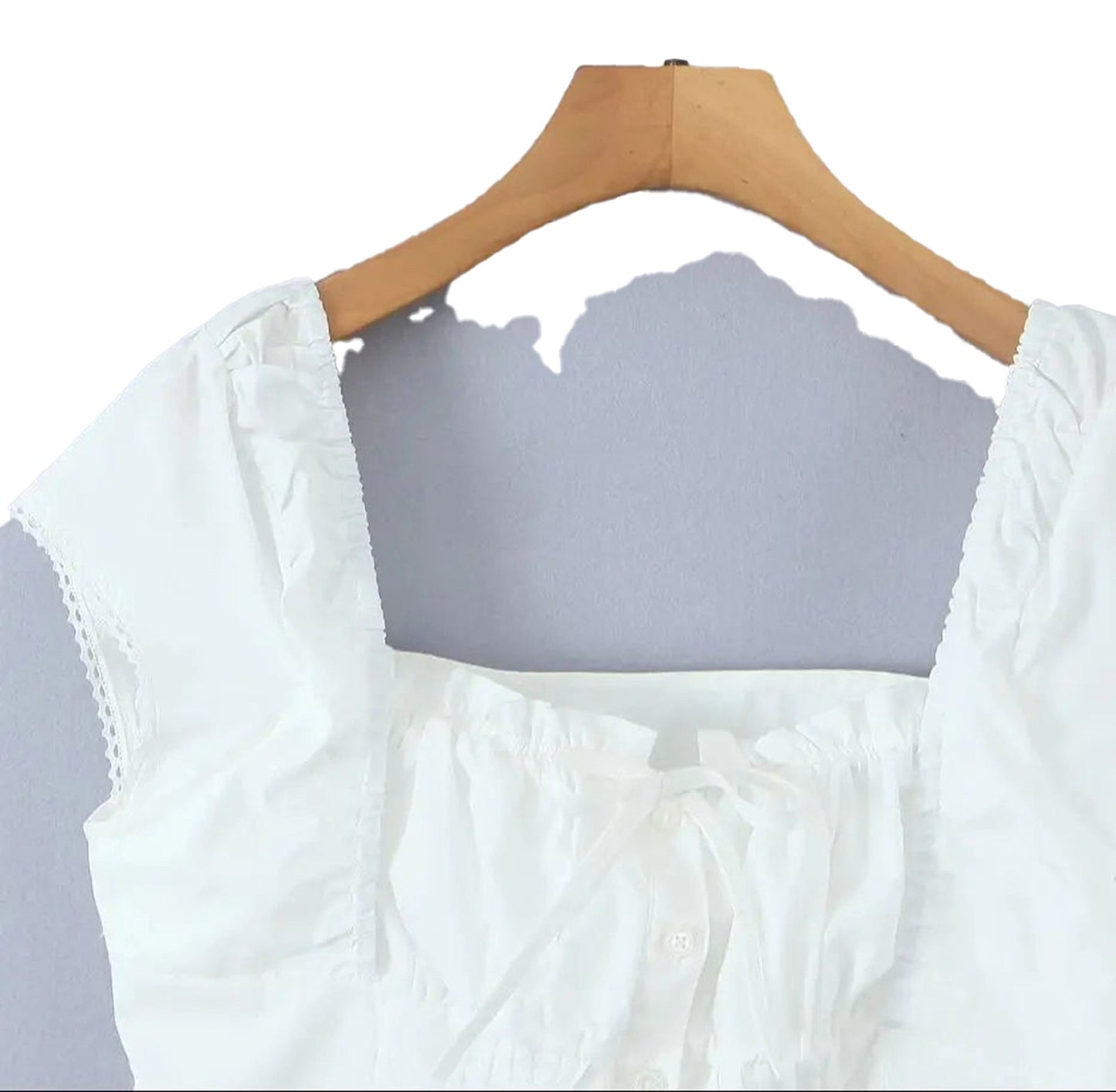 Stylish LuckeLadybug LLC white corset crop top with ruffled details and button closure