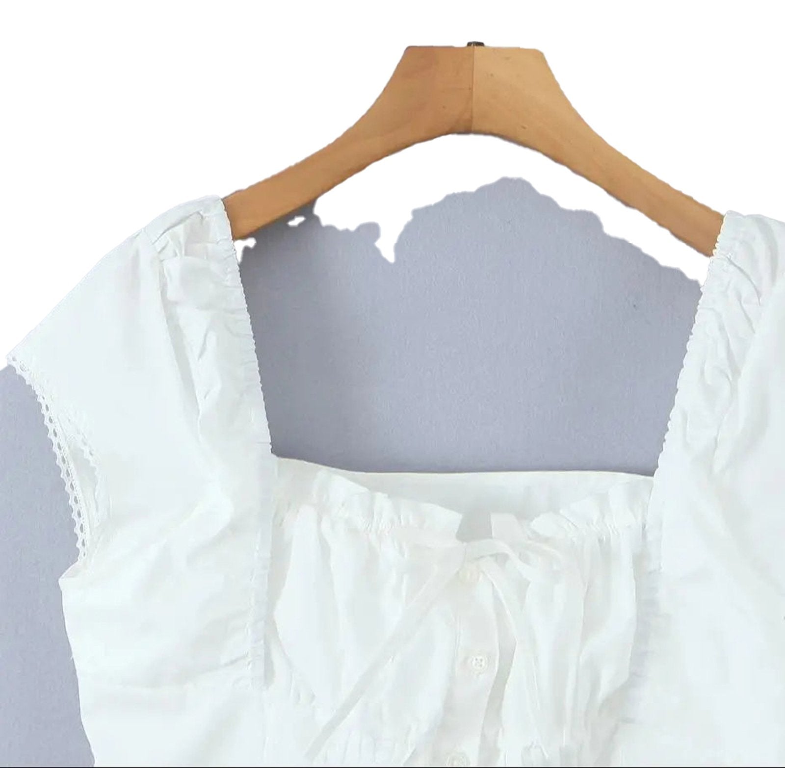 Stylish LuckeLadybug LLC white corset crop top with ruffled details and button closure