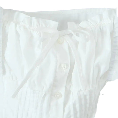 White corset crop top from LuckeLadybug LLC with ruffled sleeves and tie front detail