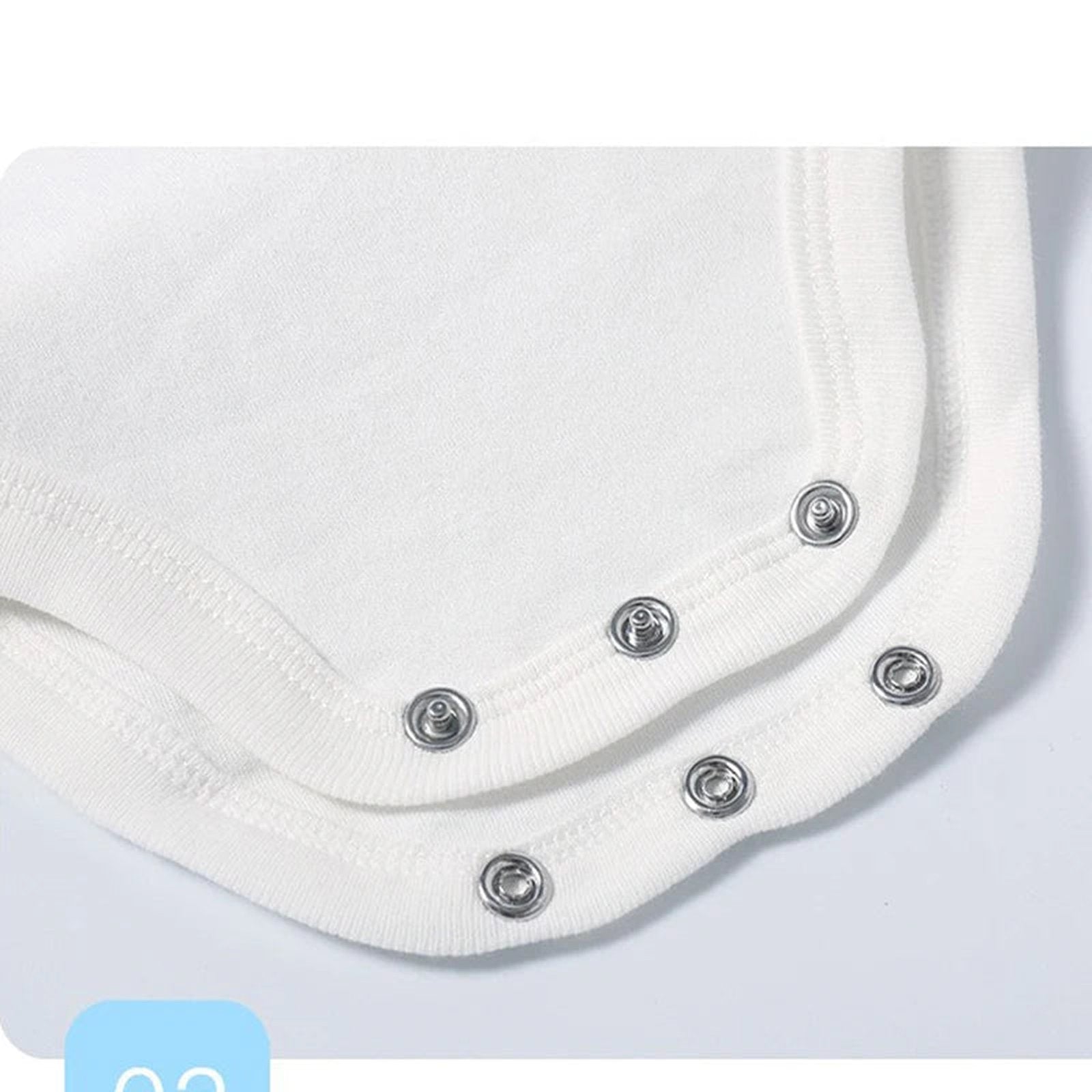 Close-up of a white cotton baby bodysuit showing snap closure design for easy dressing.
