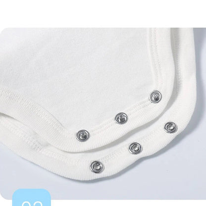 Close-up of a white cotton baby bodysuit showing snap closure design for easy dressing.