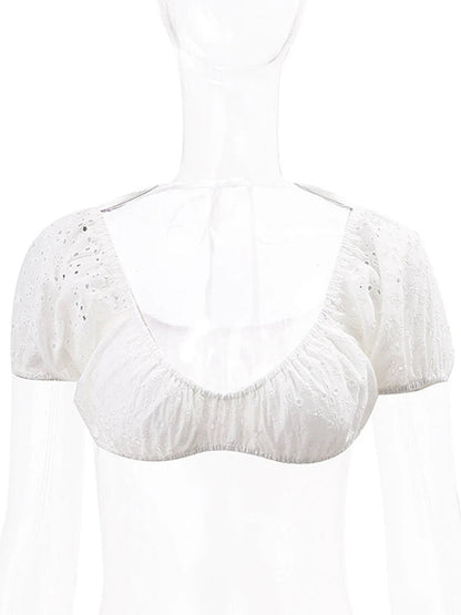 Stylish white puff sleeve crop top with delicate eyelet detailing for a trendy summer look
