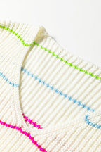 Close-up of a white v neck striped sweater featuring colorful stripes in blue, green, and pink