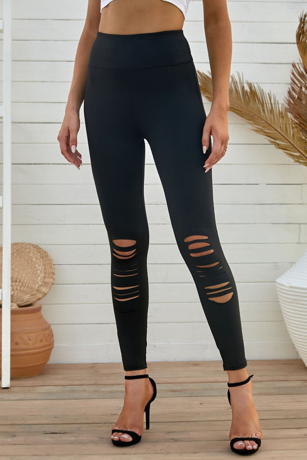 Black leggings with ripped knee details and a wide waistband for added comfort