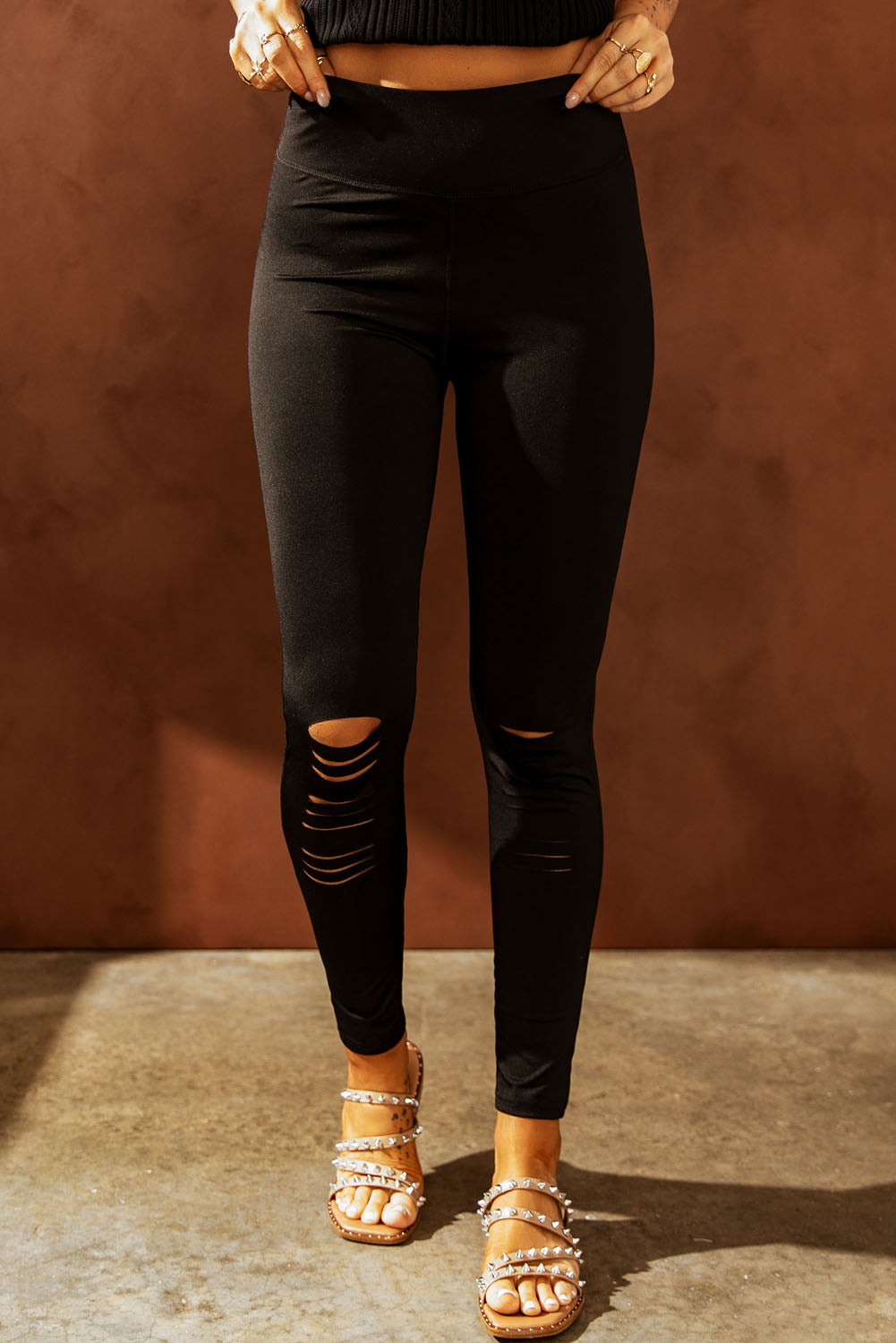 Black leggings with stylish ripped details and a comfortable wide waistband for a flattering fit
