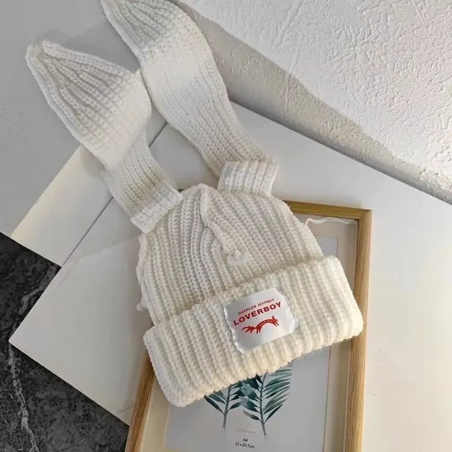 Cream winter knitted balaclava hat with a unique design and LOvERBOY tag for stylish warmth