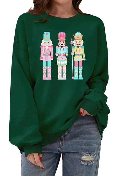 Women's Christmas pullover sweatshirt featuring colorful nutcracker design on a green background