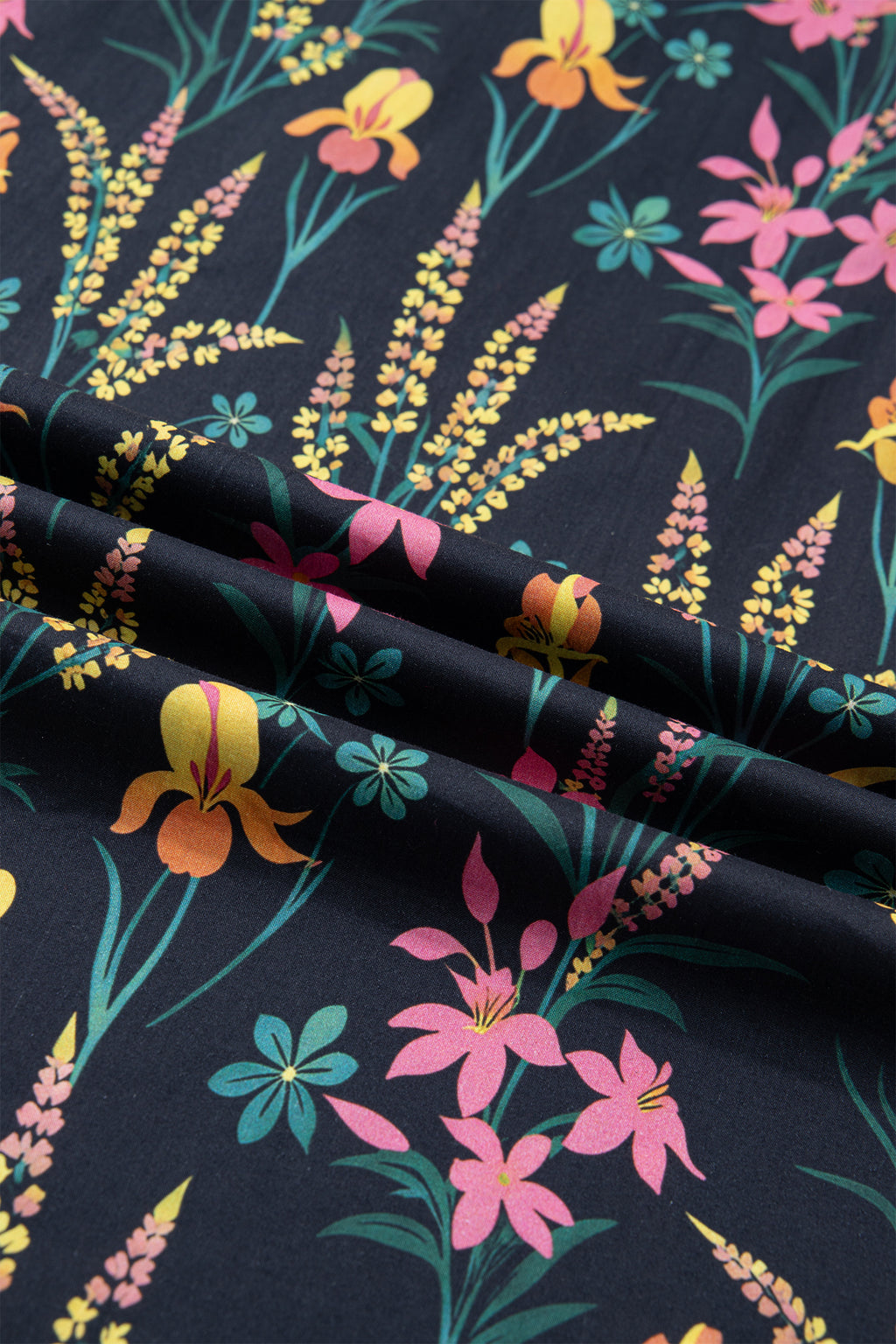 LuckeLadybug LLC short sleeve women blouse with vibrant floral print on a dark background
