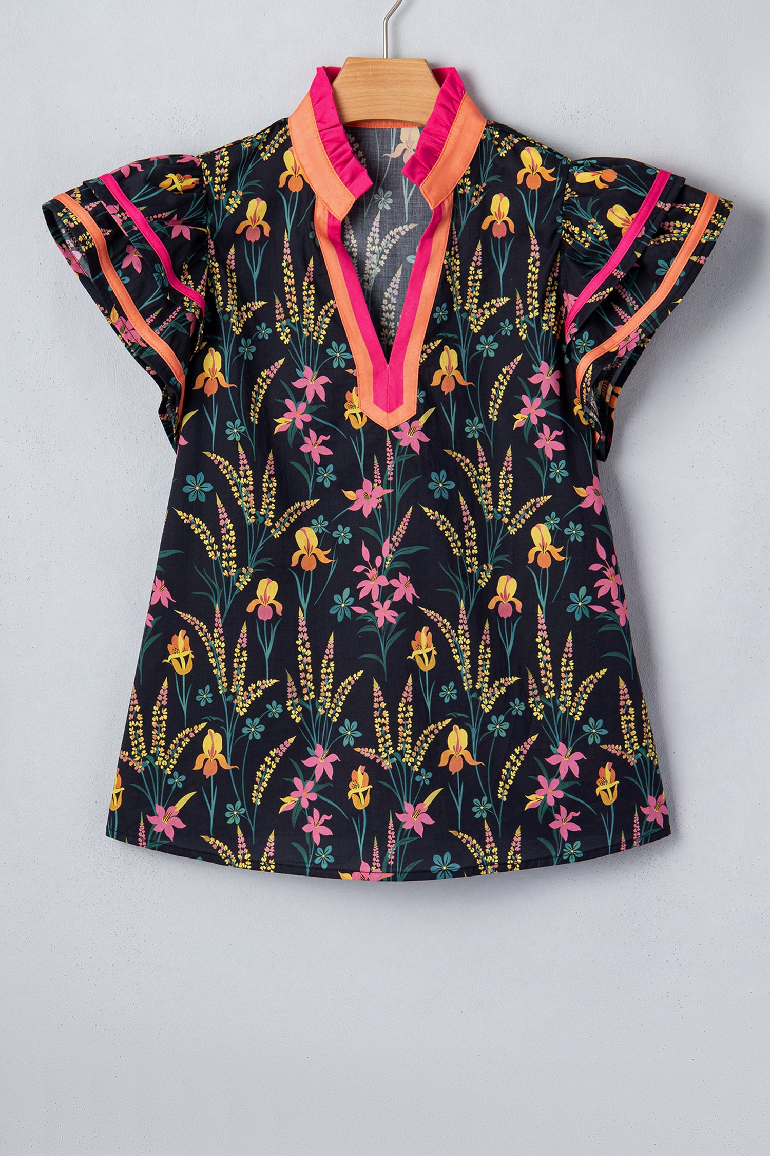 Colorful short sleeve women blouse with floral pattern and vibrant trim by LuckeLadybug LLC