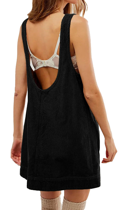 Women's corduroy pinafore dress in black with a relaxed fit and open back design