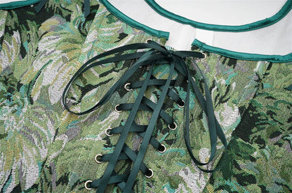 Close-up of women's corset top with green floral pattern and lace-up design for stylish outfits