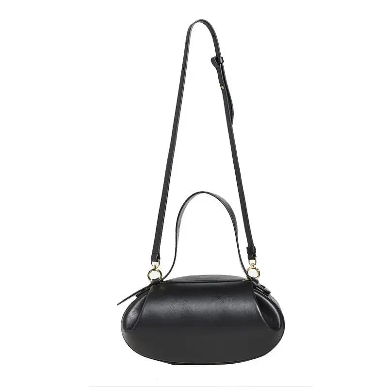 Women's crossbody round bag in black with adjustable strap and stylish design by LuckeLadybug LLC