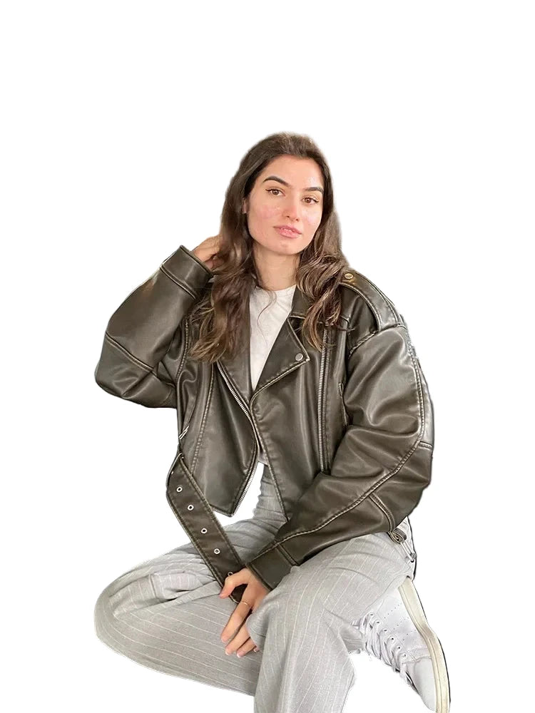 Trendy women's faux leather biker jacket in olive green, styled casually for modern fashion enthusiasts
