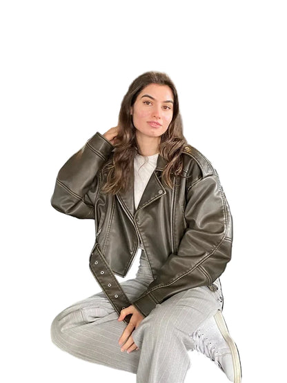 Trendy women's faux leather biker jacket in olive green, styled casually for modern fashion enthusiasts