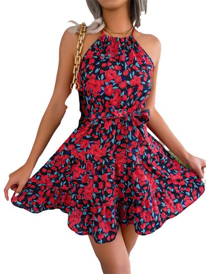 Women modeling a women's floral halter dress with a flared skirt and vibrant red and blue floral design