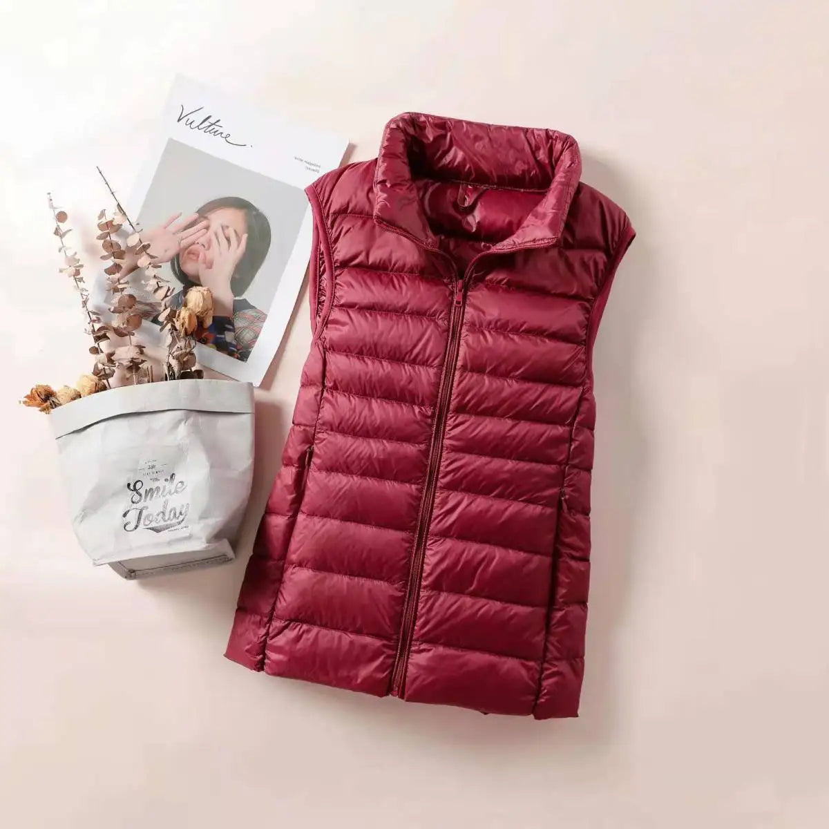 Women's lightweight down vest in burgundy, perfect for layering and staying warm