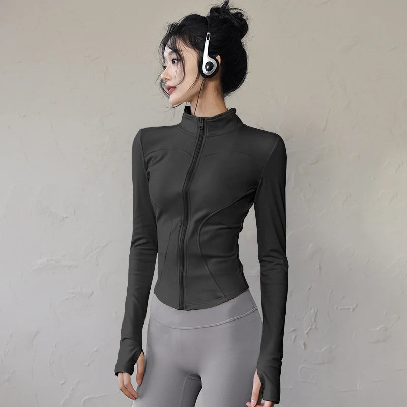 Women's long sleeve sports jacket in black with a fitted design and high collar for activewear