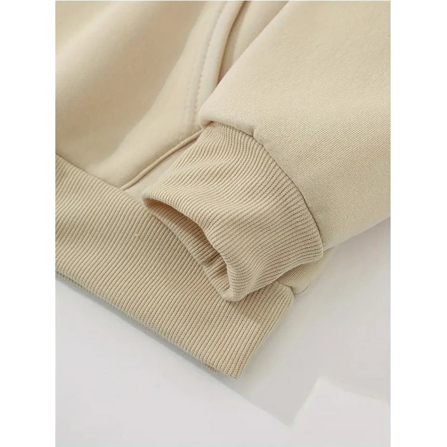 Close-up of the sleeve cuff on a women's mushroom print hoodie in a soft beige color