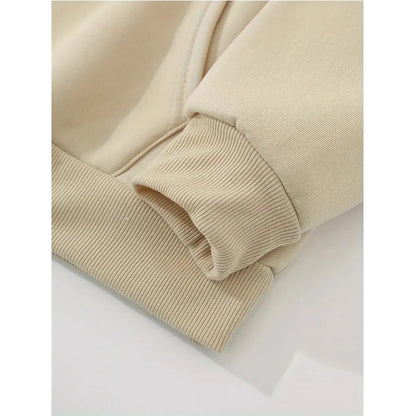 Close-up of the sleeve cuff on a women's mushroom print hoodie in a soft beige color