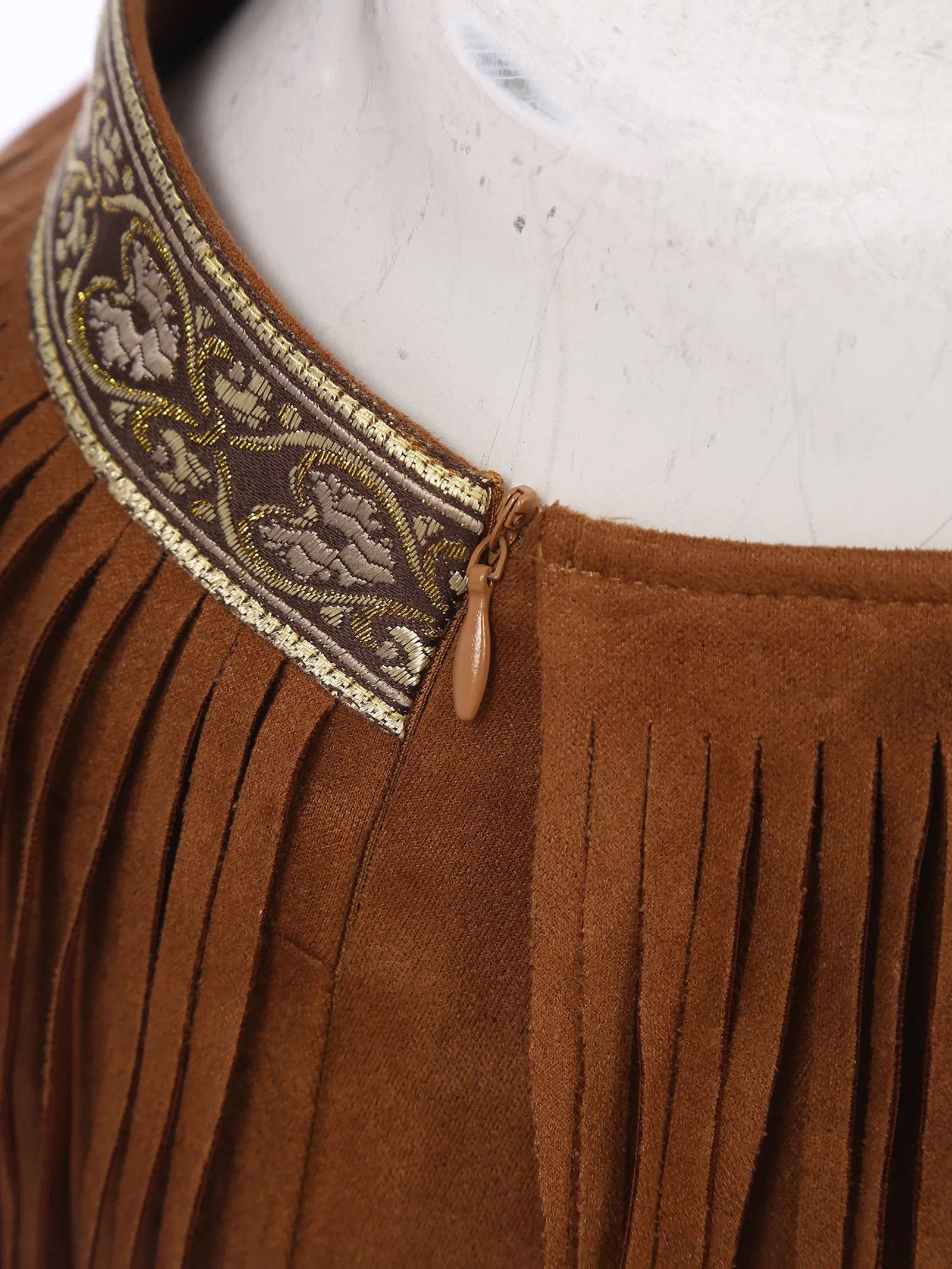 Close-up of women's Native American costume with decorative trim and fringe detailing