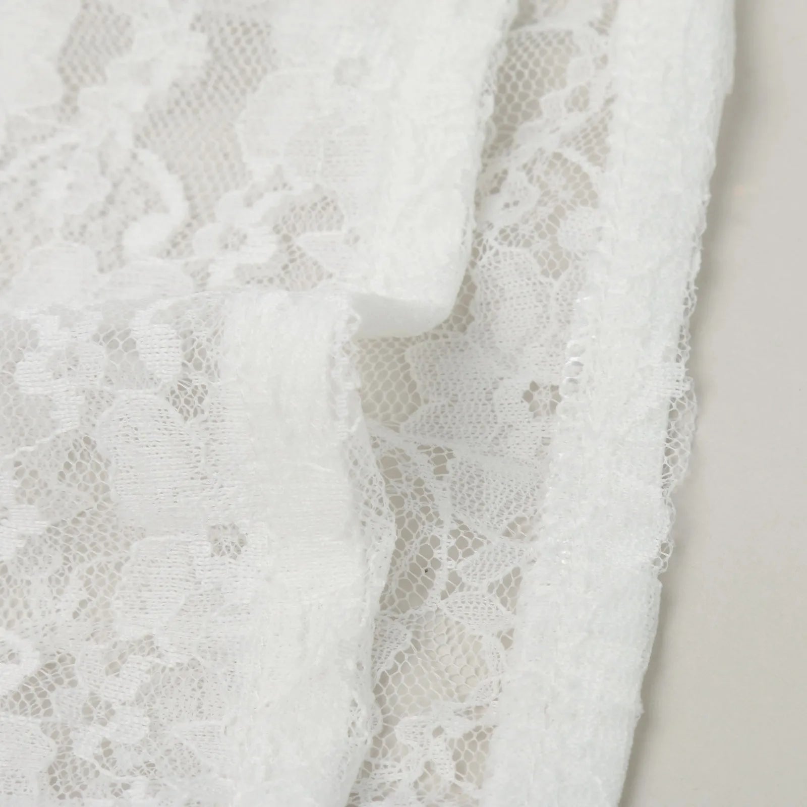White lace fabric for a women's Oktoberfest dirndl blouse with delicate floral patterns