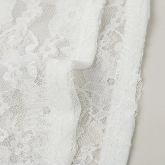 White lace fabric for a women's Oktoberfest dirndl blouse with delicate floral patterns