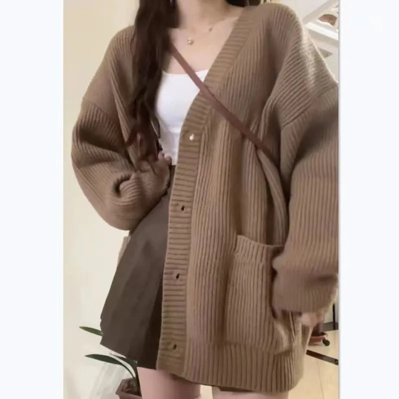 Cozy women's oversized knit cardigan in beige with buttons and pockets for a stylish layered look