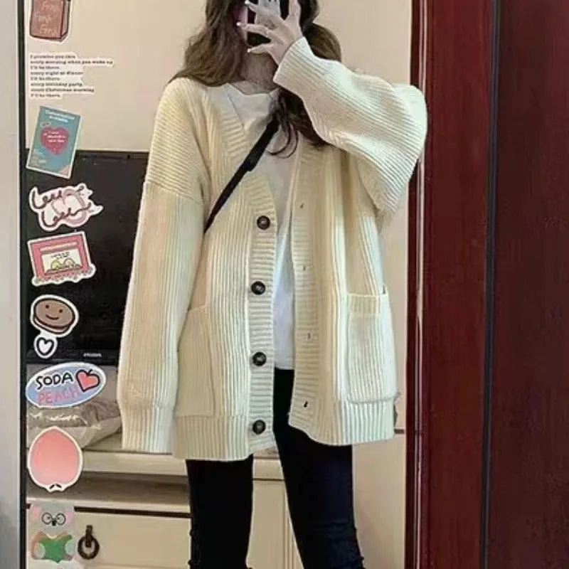 Cozy women's oversized knit cardigan in cream with buttons and pockets for chilly days