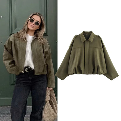 Model wearing a women's vintage bomber jacket in olive green, styled with high-waisted jeans