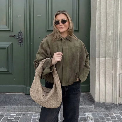 Chic women wearing a women's vintage bomber jacket styled with sunglasses and a fashionable bag