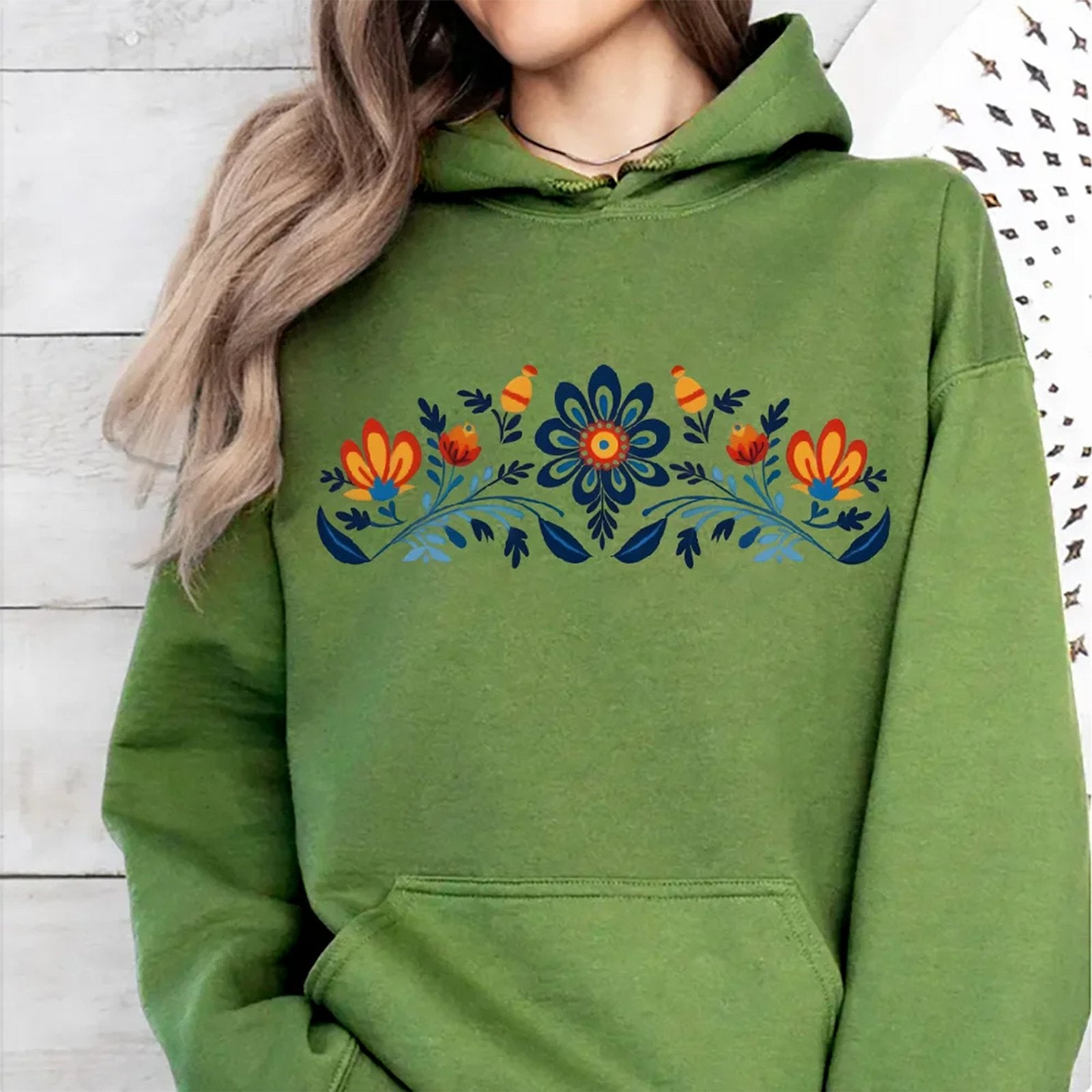 Women's washed hoodie with national symbols featuring floral and bird designs in vibrant colors