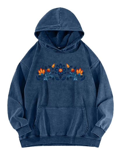 Women's washed hoodie with national symbols featuring colorful floral embroidery on a blue background