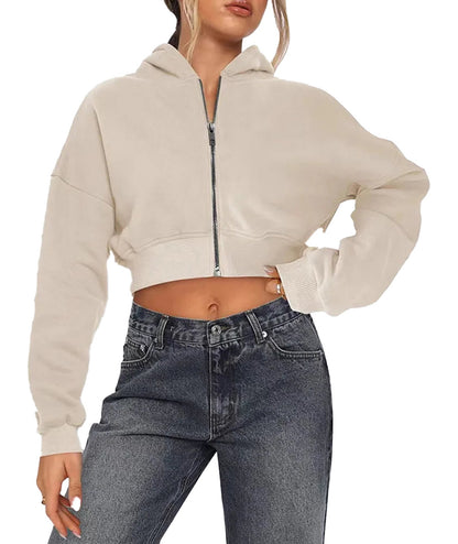 Women's zip hoodie oversized in beige, cropped design with a relaxed fit, paired with high-waisted jeans