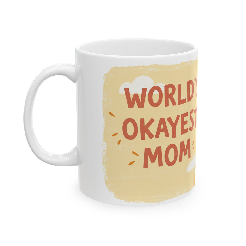 White ceramic Worlds Okayest Mom mug with beige background and playful text design