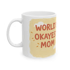 White ceramic Worlds Okayest Mom mug with beige background and playful text design