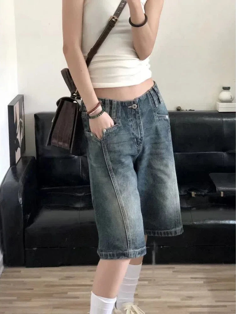 Stylish model wearing Y2K baggy denim shorts for women with a casual tank top and handbag