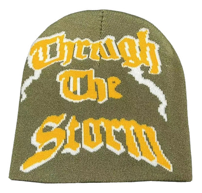 Olive green Y2K beanie for women and men featuring bold 'Through The Storm' text design