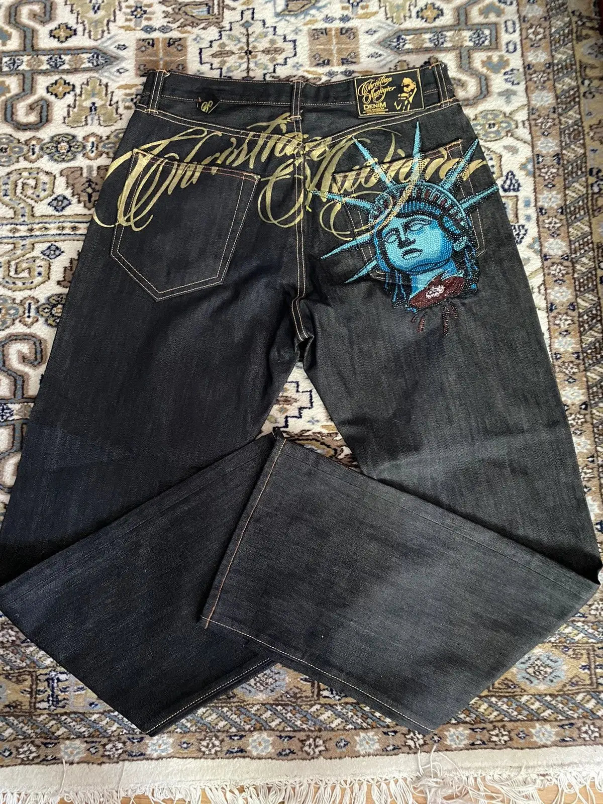 LuckeLadybug LLC Y2K Statue of Liberty jeans with vibrant blue design and unique stitching details