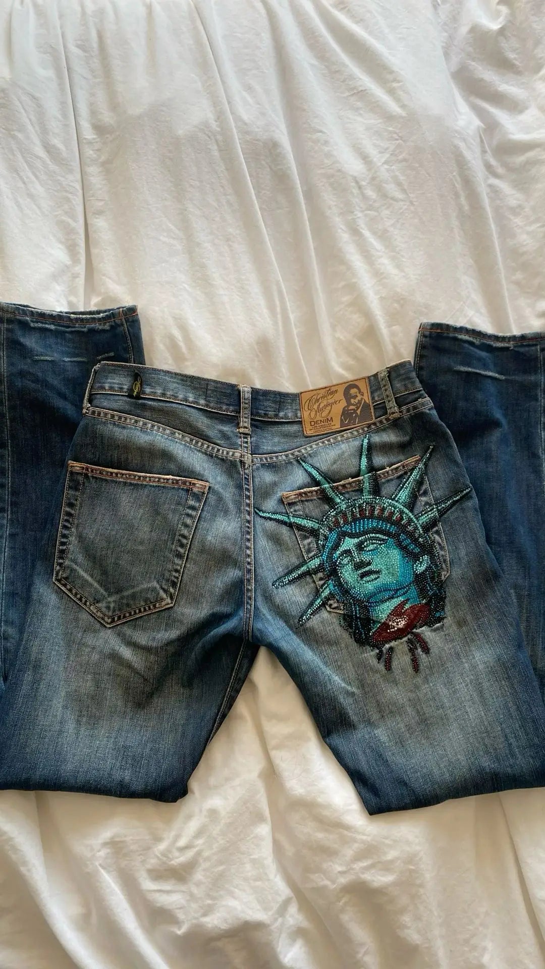Y2K Statue of Liberty jeans with detailed embroidery on the back for a vintage-inspired look