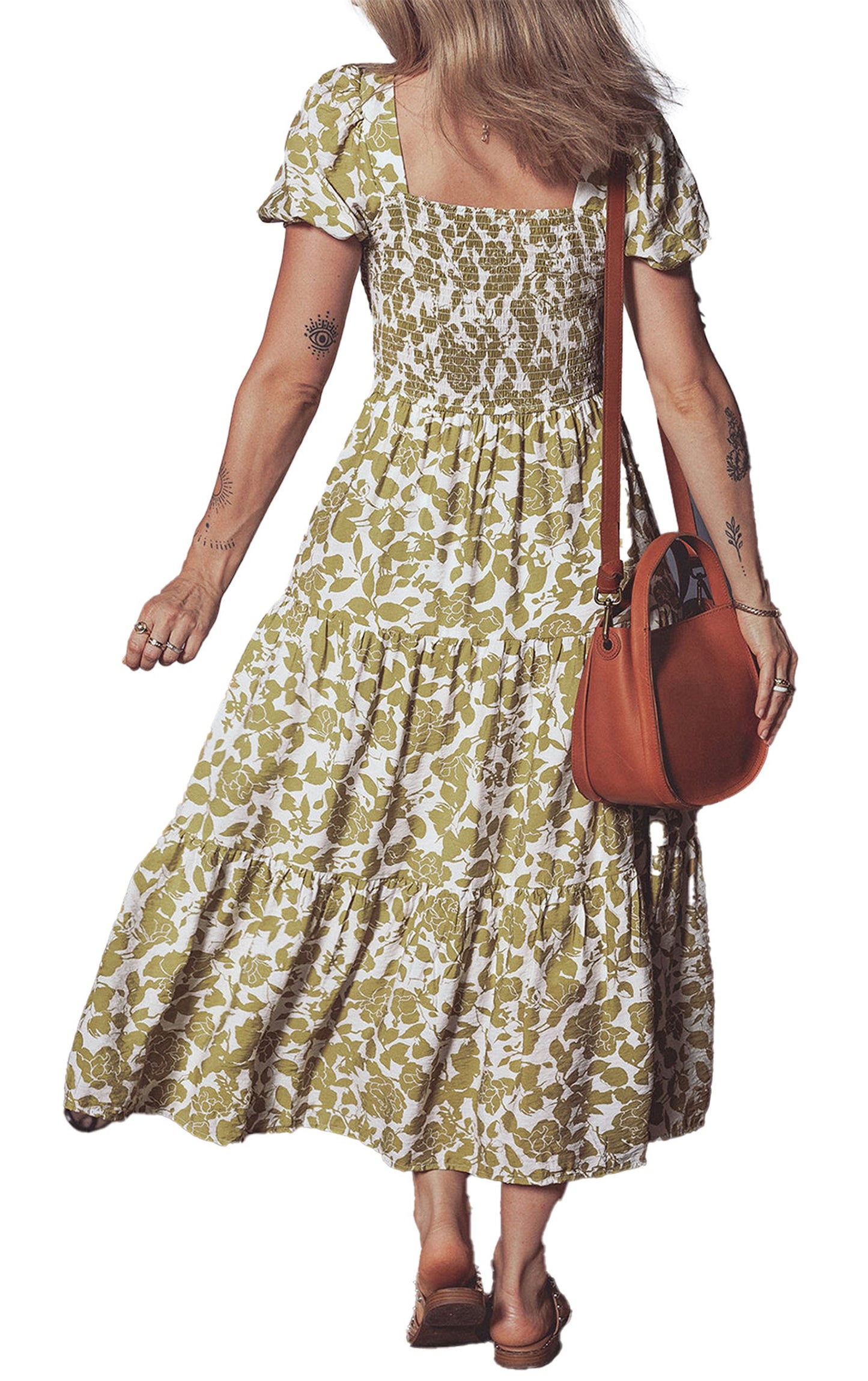 Back view of a woman in a yellow boho floral maxi dress with puff sleeves and tiered skirt