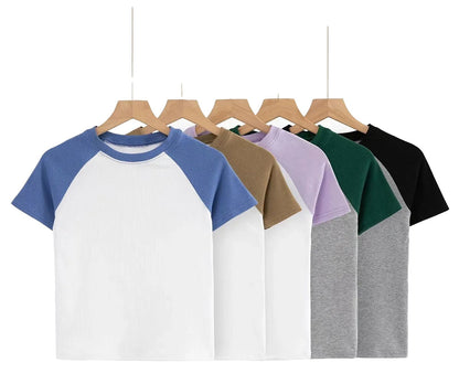 Collection of 90s vintage crop tops in various colors with raglan sleeves from LuckeLadybug LLC